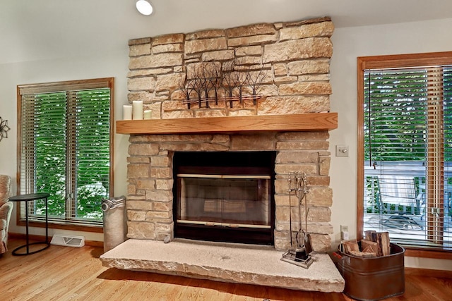16625 Tanglewood Dr, Brookfield, WI 53005 - detailed view of a stone fireplace, wood finished floors, and baseboards