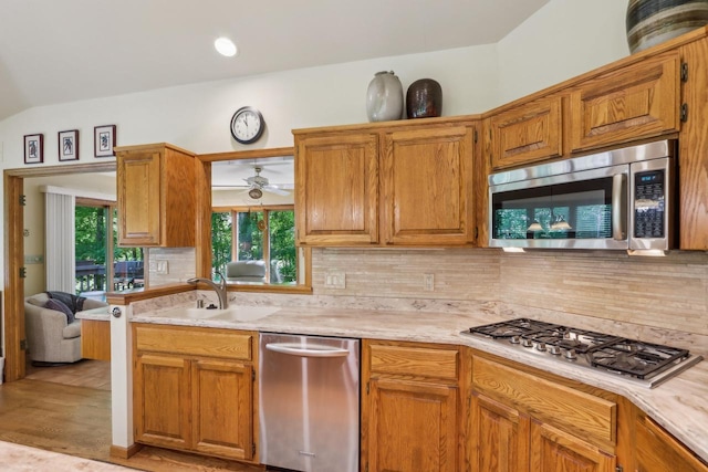 16625 Tanglewood Dr, Brookfield, WI 53005 - kitchen featuring stainless steel appliances, light countertops, a sink, backsplash, and ceiling fan