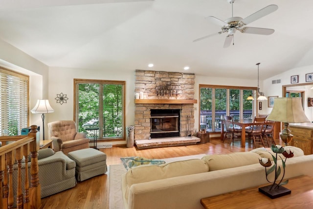 16625 Tanglewood Dr, Brookfield, WI 53005 - living area featuring lofted ceiling, wood finished floors, ceiling fan, a stone fireplace, and recessed lighting