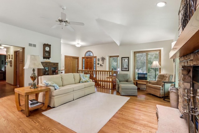 16625 Tanglewood Dr, Brookfield, WI 53005 - living room featuring light wood finished floors, a ceiling fan, and a stone fireplace