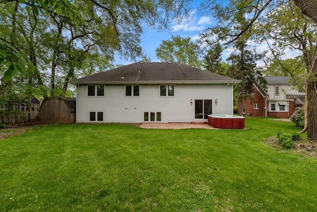 6241 N 118th St, Milwaukee, WI 53225 - back of property with a hot tub, a patio area, and a lawn