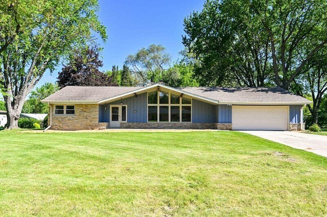 17620 Continental Dr, Brookfield, WI 53045 - mid-century home with stone siding, an attached garage, driveway, and a front lawn