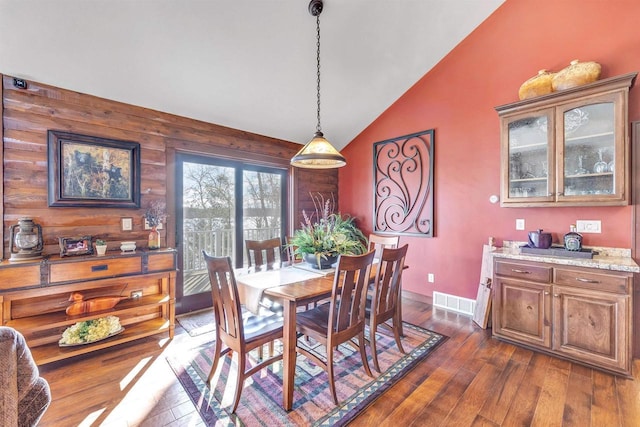 W12900 W Shore Dr, Crivitz, WI 54114 - dining area with vaulted ceiling, dark wood finished floors, and baseboards