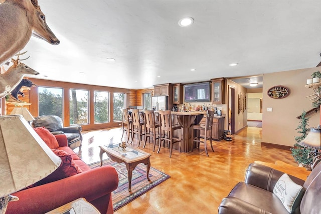 W12900 W Shore Dr, Crivitz, WI 54114 - living room featuring concrete floors, recessed lighting, wet bar, and baseboards