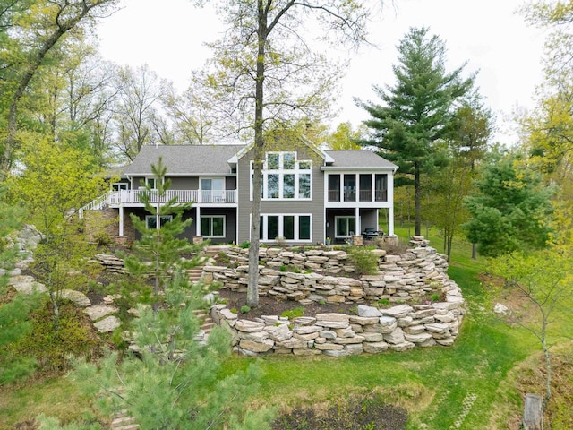 W12900 W Shore Dr, Crivitz, WI 54114 - back of property with a sunroom, a deck, and roof with shingles