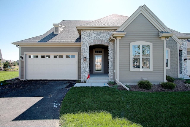 1626 Belmont Ln Unit 27, Oconomowoc, WI 53066 - french country home with a garage, driveway, a front lawn, and stone siding