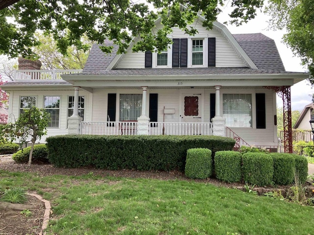 315 Lampert St, Oshkosh, WI 54901 - view of front of home with covered porch, roof with shingles, a front lawn, and a chimney