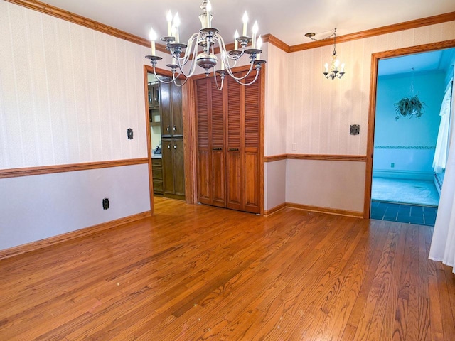 315 Lampert St, Oshkosh, WI 54901 - empty room featuring a chandelier, wood finished floors, crown molding, and baseboards