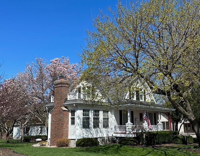 315 Lampert St, Oshkosh, WI 54901 - view of front of property featuring a porch, a front lawn, and a chimney