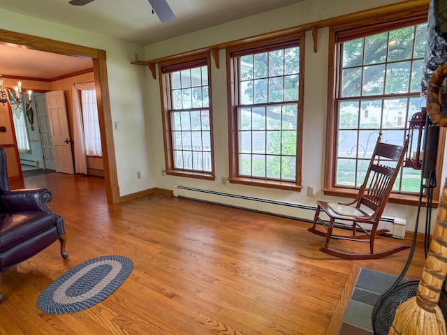 315 Lampert St, Oshkosh, WI 54901 - sitting room featuring wood finished floors, healthy amount of natural light, a chandelier, and crown molding