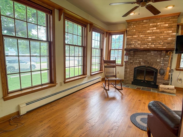 315 Lampert St, Oshkosh, WI 54901 - living room featuring a baseboard heating unit, hardwood / wood-style floors, a ceiling fan, baseboards, and recessed lighting