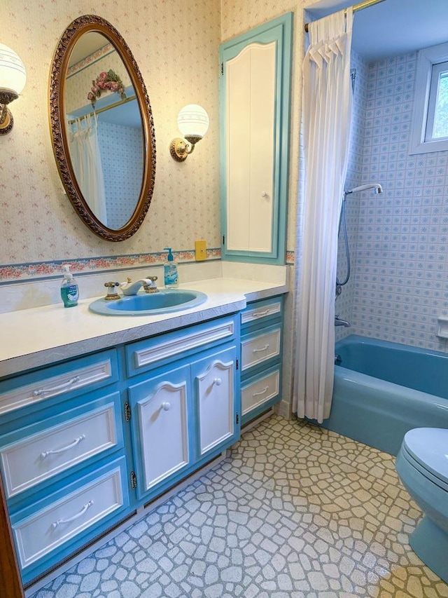 315 Lampert St, Oshkosh, WI 54901 - bathroom with wallpapered walls, vanity, toilet, and shower / bathtub combination with curtain