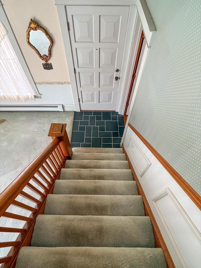 315 Lampert St, Oshkosh, WI 54901 - stairway with wallpapered walls, a baseboard heating unit, and tile patterned flooring