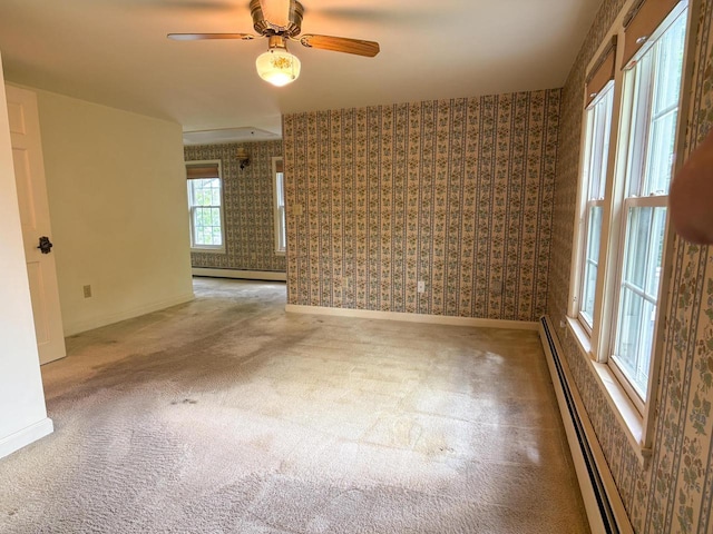 315 Lampert St, Oshkosh, WI 54901 - empty room featuring wallpapered walls, a baseboard heating unit, carpet floors, baseboards, and ceiling fan