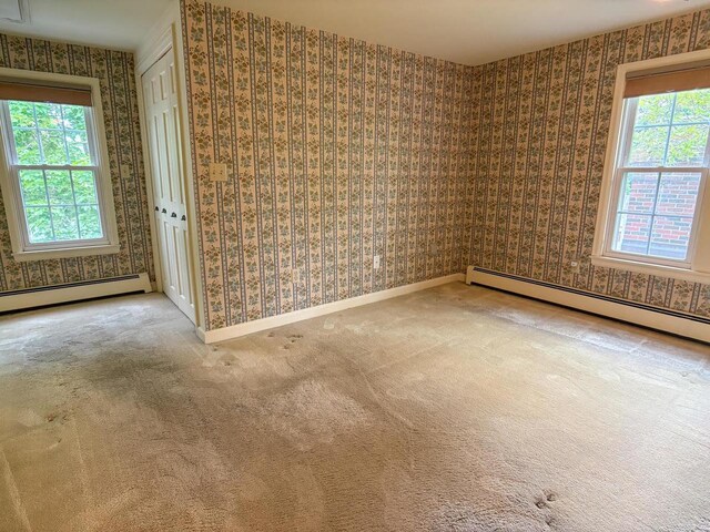 315 Lampert St, Oshkosh, WI 54901 - carpeted spare room featuring wallpapered walls, a baseboard heating unit, and baseboards