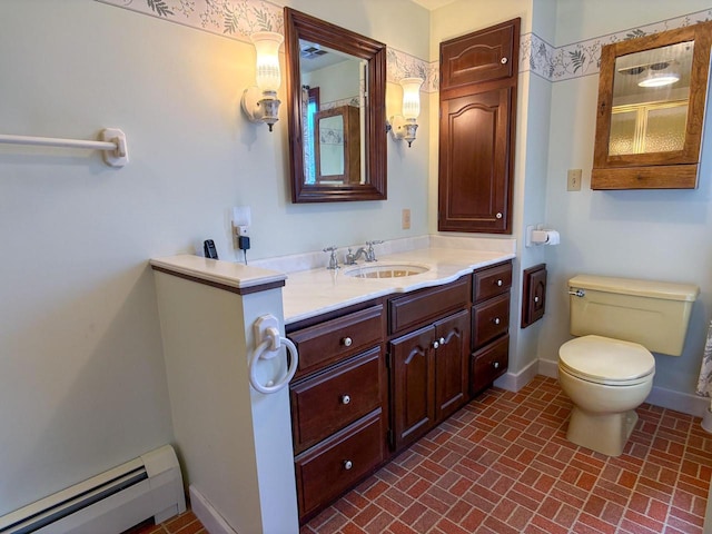 315 Lampert St, Oshkosh, WI 54901 - bathroom with a baseboard heating unit, brick patterned flooring, vanity, toilet, and baseboards
