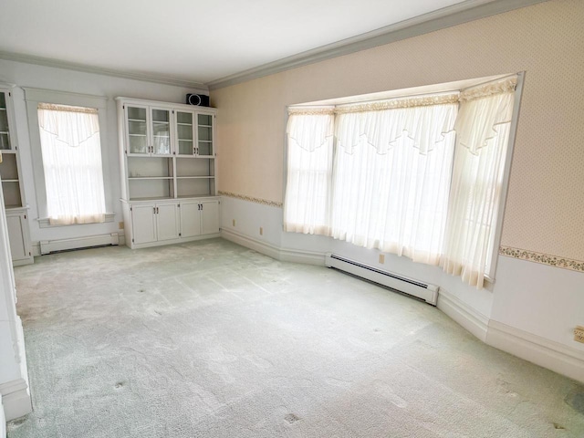 315 Lampert St, Oshkosh, WI 54901 - empty room featuring baseboard heating, ornamental molding, and light colored carpet