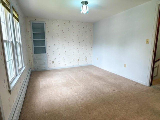 315 Lampert St, Oshkosh, WI 54901 - carpeted spare room with a baseboard heating unit, baseboards, and wallpapered walls