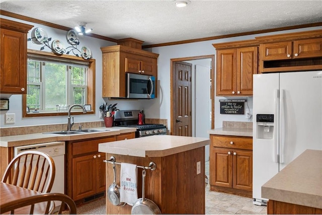 505 Lake Ave, Frederic, WI 54837 - kitchen with appliances with stainless steel finishes, a sink, light countertops, a textured ceiling, and brown cabinets