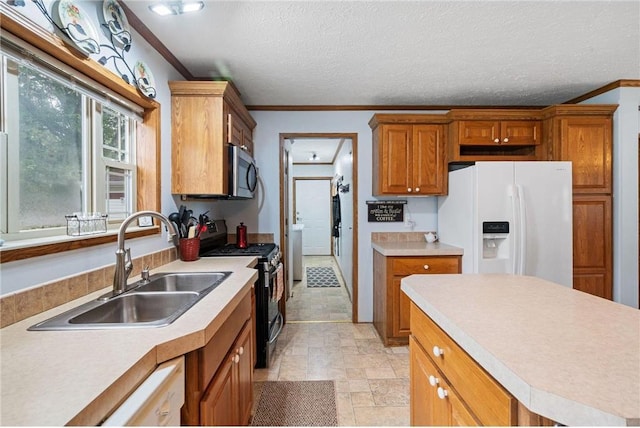 505 Lake Ave, Frederic, WI 54837 - kitchen with white fridge with ice dispenser, stainless steel microwave, a sink, gas stove, and crown molding