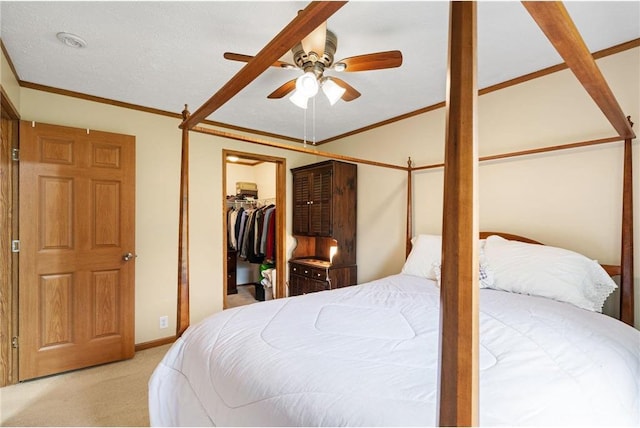 505 Lake Ave, Frederic, WI 54837 - bedroom featuring light colored carpet, crown molding, a ceiling fan, and a walk in closet