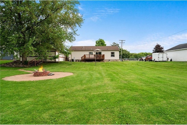 505 Lake Ave, Frederic, WI 54837 - view of grassy yard featuring a fire pit and a deck