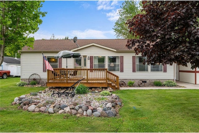 505 Lake Ave, Frederic, WI 54837 - back of property with a wooden deck, a yard, and a shingled roof