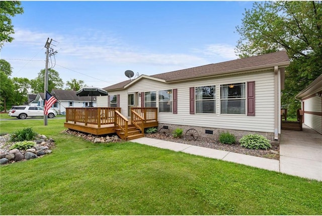 505 Lake Ave, Frederic, WI 54837 - manufactured / mobile home featuring crawl space, a wooden deck, and a front yard