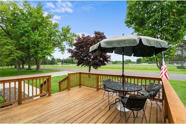 505 Lake Ave, Frederic, WI 54837 - wooden deck with a lawn and outdoor dining area