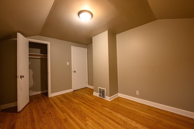 3776 S 16th St, Milwaukee, WI 53221 - unfurnished bedroom with lofted ceiling, wood finished floors, a closet, and baseboards