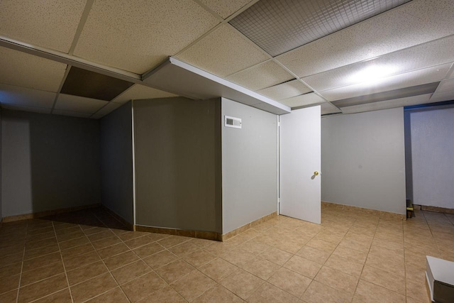 3776 S 16th St, Milwaukee, WI 53221 - finished below grade area with a drop ceiling, baseboards, and tile patterned flooring