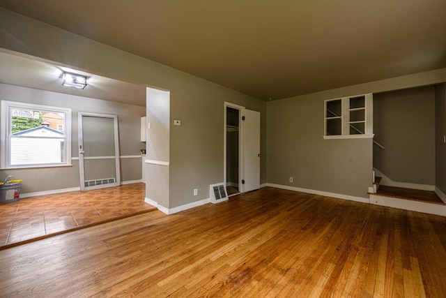 3776 S 16th St, Milwaukee, WI 53221 - empty room featuring wood finished floors, baseboards, and stairway