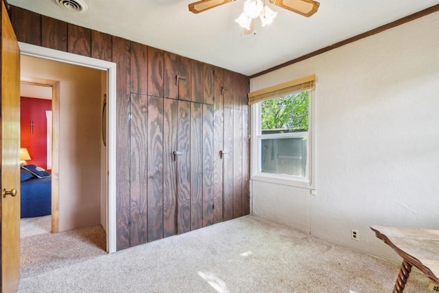 950 N Dousman Rd, Summit, WI 53066 - unfurnished bedroom with carpet, wood walls, and a ceiling fan