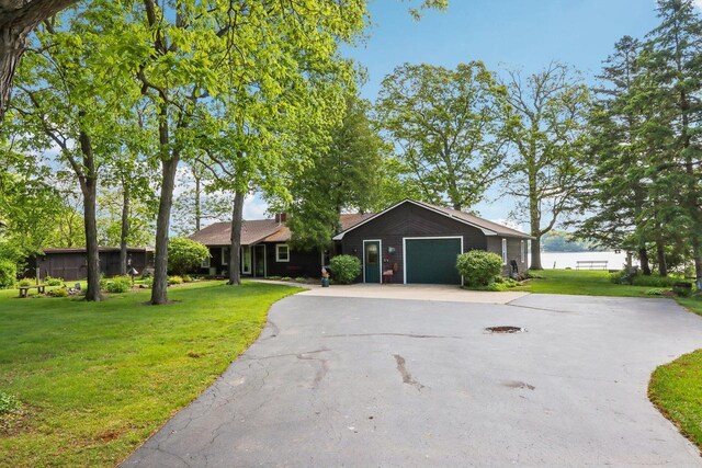 950 N Dousman Rd, Summit, WI 53066 - ranch-style home with asphalt driveway, a garage, and a front lawn