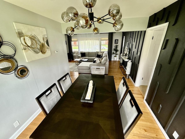 219 W Daphne St, Milwaukee, WI 53217 - dining room featuring a chandelier, light wood-type flooring, and baseboards