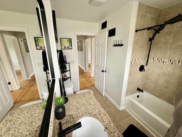 219 W Daphne St, Milwaukee, WI 53217 - bathroom with shower / bath combination, baseboards, vanity, toilet, and tile patterned flooring