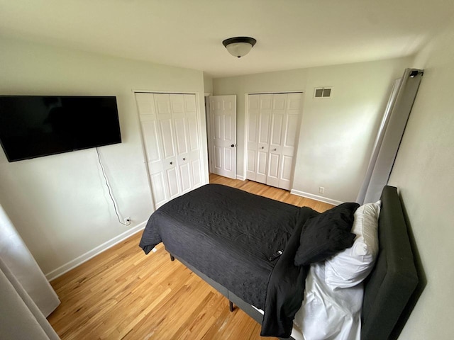 219 W Daphne St, Milwaukee, WI 53217 - bedroom featuring multiple closets, baseboards, and wood finished floors