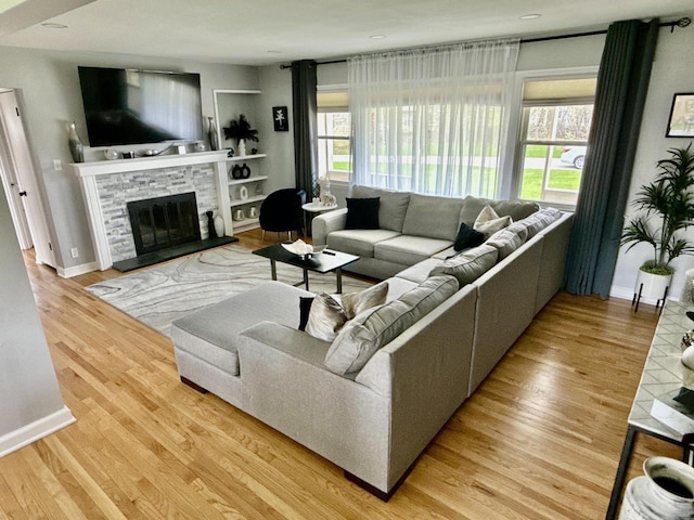219 W Daphne St, Milwaukee, WI 53217 - living area featuring healthy amount of natural light, a stone fireplace, and wood finished floors