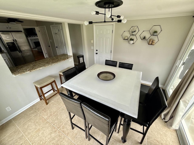 219 W Daphne St, Milwaukee, WI 53217 - dining area with ornamental molding, baseboards, and light tile patterned floors