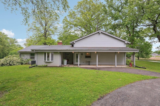 954 N Dousman Rd, Summit, WI 53066 - view of front of property with a front yard, a chimney, driveway, and central air condition unit