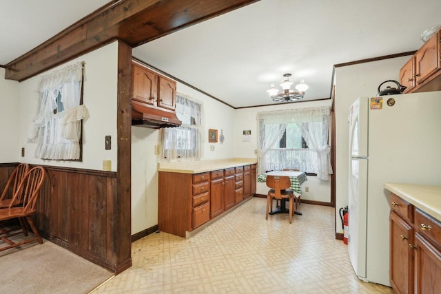 954 N Dousman Rd, Summit, WI 53066 - kitchen with freestanding refrigerator, a chandelier, brown cabinetry, ornamental molding, and light countertops