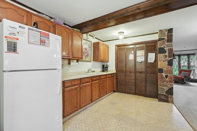 954 N Dousman Rd, Summit, WI 53066 - kitchen featuring freestanding refrigerator, a sink, light countertops, light carpet, and brown cabinets