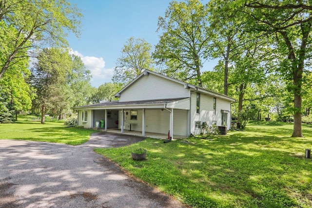 954 N Dousman Rd, Summit, WI 53066 - view of front of home with driveway, a front lawn, and view of scattered trees