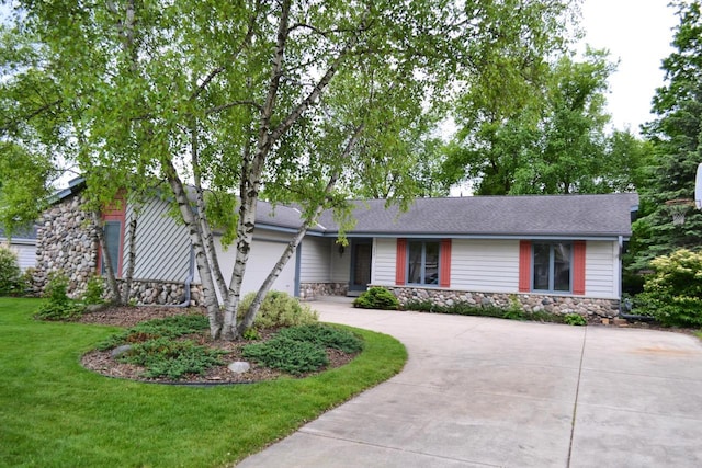 7827 W Canterbury Ct, Franklin, WI 53132 - view of front of home featuring stone siding, concrete driveway, and a front lawn
