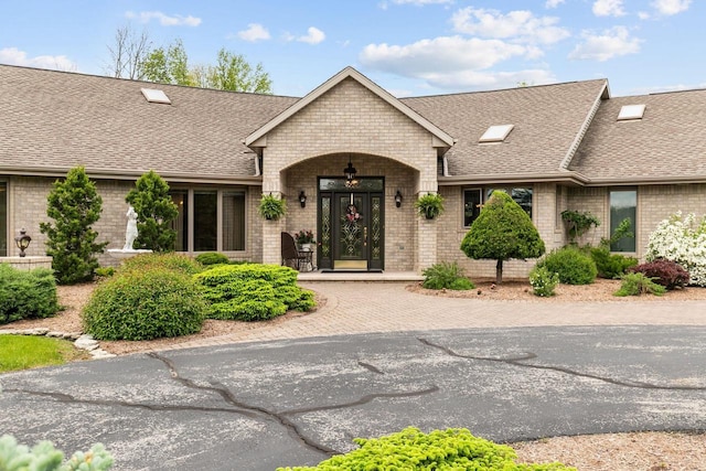 N4653 Thompson Rd, Shiocton, WI 54170 - view of front of house featuring a shingled roof and brick siding