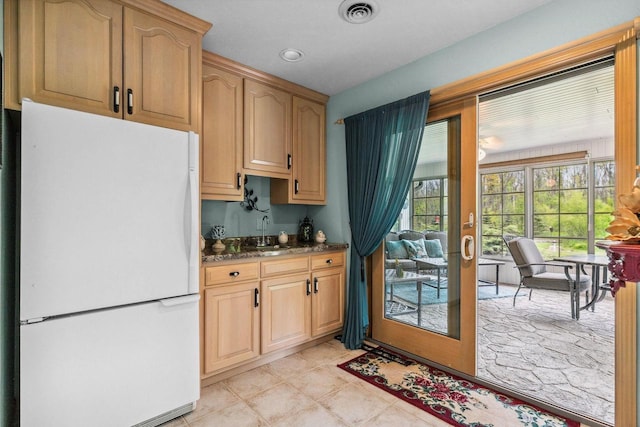 N4653 Thompson Rd, Shiocton, WI 54170 - kitchen with freestanding refrigerator, a sink, and dark stone countertops