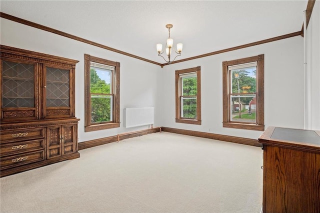 632 E 2nd St, New Richmond, WI 54017 - carpeted spare room with radiator heating unit, a chandelier, and ornamental molding
