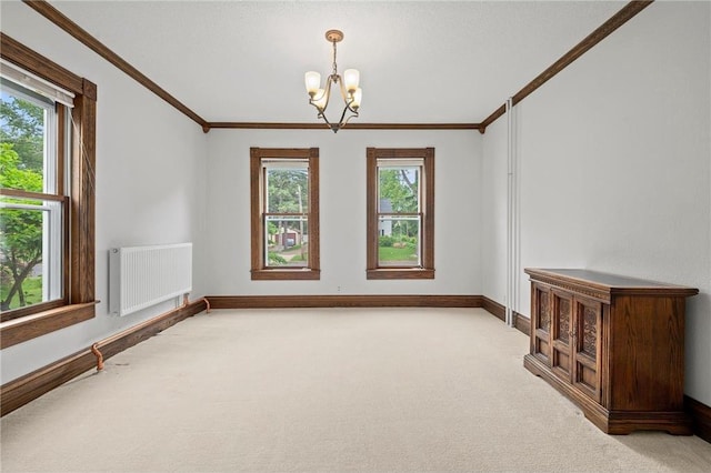 632 E 2nd St, New Richmond, WI 54017 - unfurnished room with radiator heating unit, a chandelier, light carpet, and crown molding