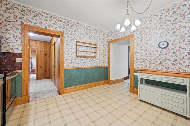 632 E 2nd St, New Richmond, WI 54017 - unfurnished dining area with wallpapered walls, a chandelier, crown molding, and a wainscoted wall
