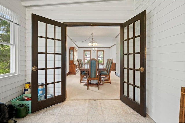 632 E 2nd St, New Richmond, WI 54017 - doorway featuring french doors, a chandelier, plenty of natural light, and light carpet